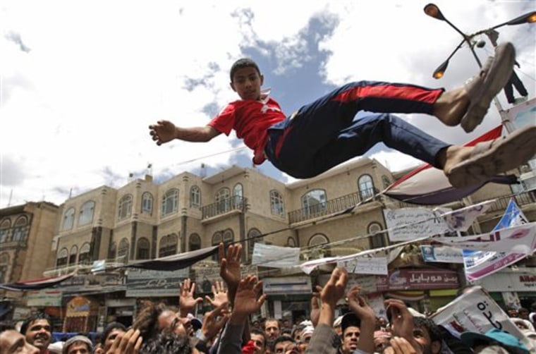 Anti-government protesters reach up to catch a youth after throwing him into the air during a demonstration demanding the resignation of Yemeni President Ali Abdullah Saleh, in Sanaa, Yemen, on May 21.